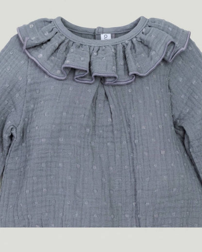 Close-up detail of frilled ruffle collar and textured plumeti double gauze cotton on slate grey-blue Spanish baby romper.