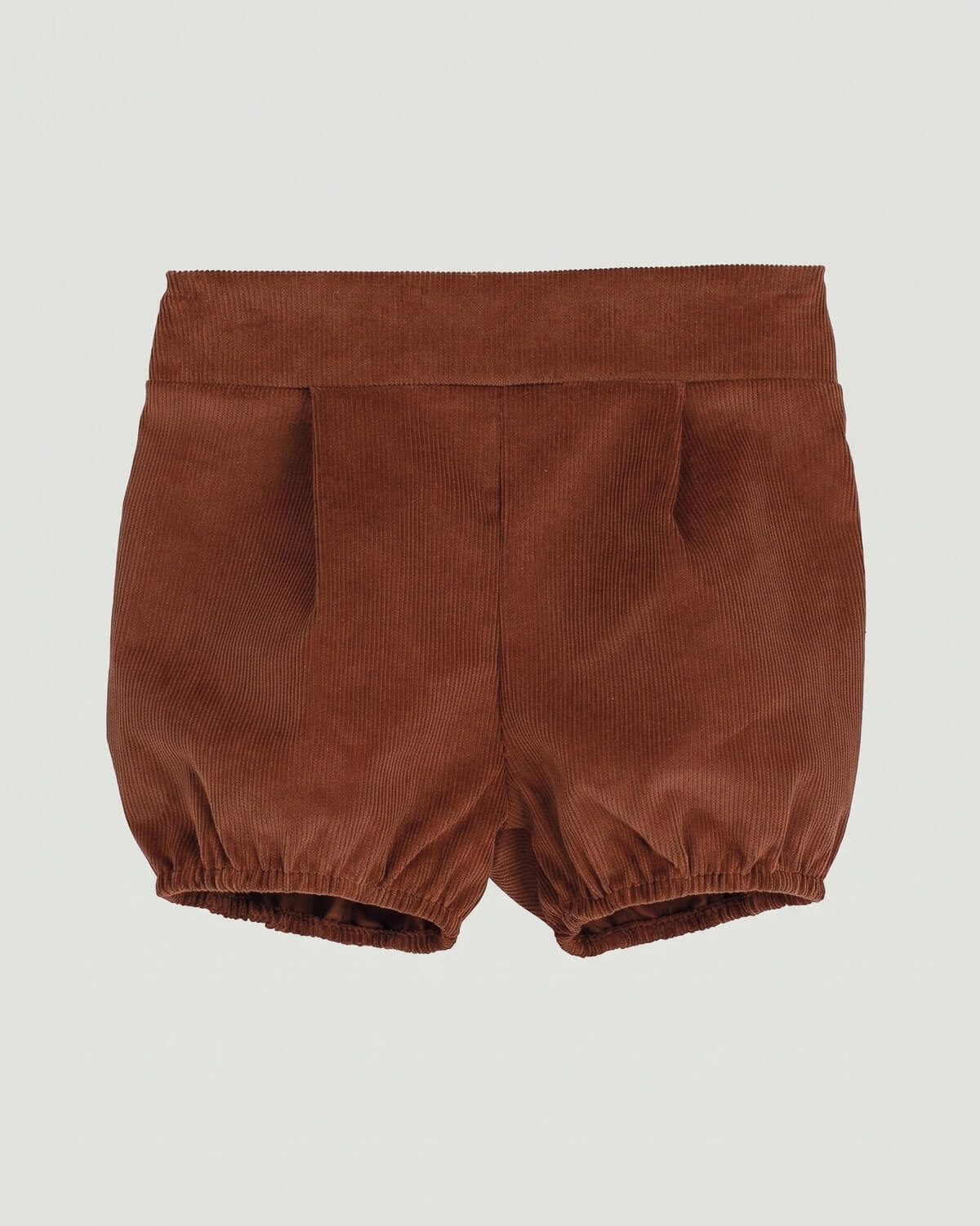 Detail view of traditional Spanish baby boy bloomers in rust brown corduroy fabric.
