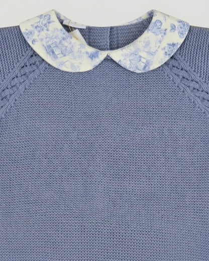Close-up detail of Peter Pan toile de Jouy collar and raglan sleeve knit pattern on baby blue jumper.