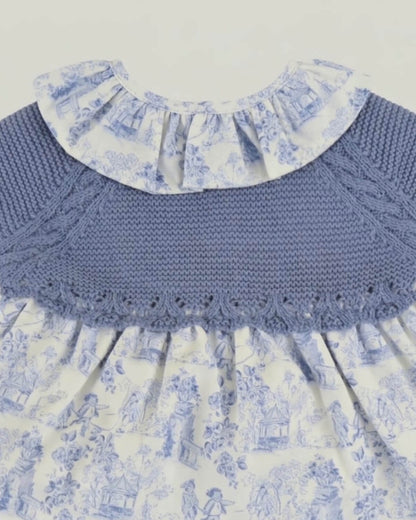 Close-up detail of dusty blue knitted yoke with scalloped hem and frilled toile de Jouy collar on Spanish baby dress.