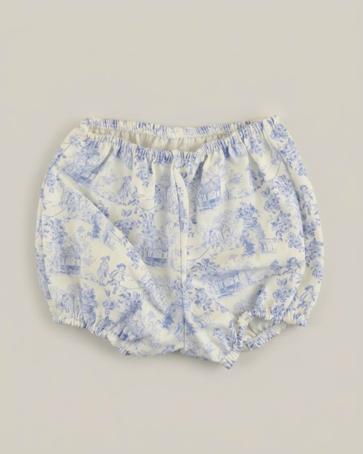 Detail view of traditional Spanish baby bloomers in blue and white toile de Jouy printed cotton fabric.