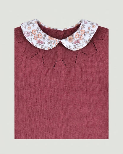 Close-up detail of floral printed Peter Pan collar and delicate eyelet knit yoke on burgundy baby jumper.
