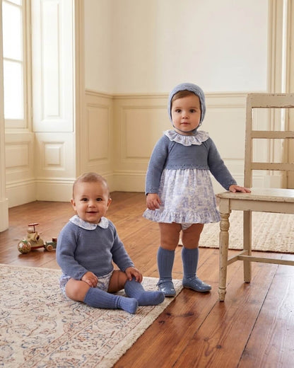 Baby brother and sister wearing matching Dulce de Fresa traditional Spanish dusty blue knitted sets with toile de Jouy details.