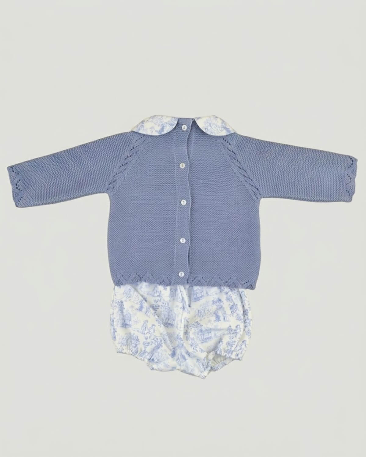 Back view of traditional Spanish baby blue knitted jumper showing button fastening and matching printed bloomers.