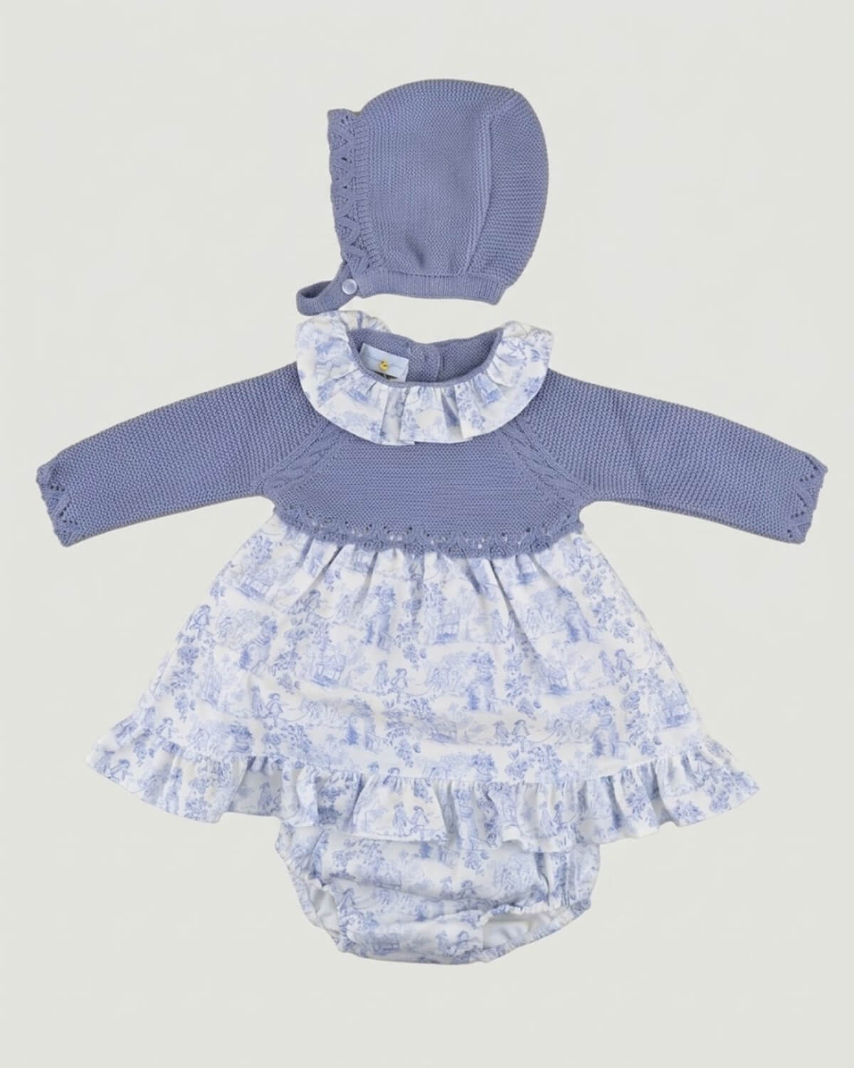 Dulce de Fresa 3-piece traditional Spanish baby girl dress set with dusty blue knitted yoke, toile de Jouy skirt, bloomers and matching bonnet.